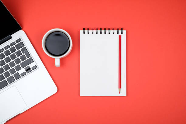 istock Minimal working desk with laptop and blank notepad page. Top view, flat lay and copy space 1047639962