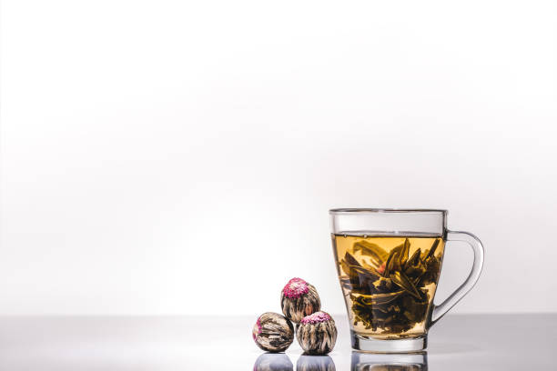 istock cup of chinese flowering tea with tea balls on table 1047640342