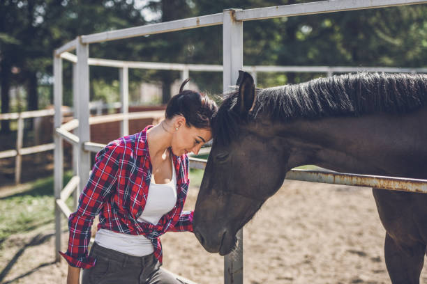 istock young woman and horse 1047640850