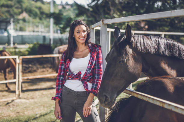 istock young woman and horse 1047640976