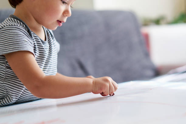 istock Cute child is drawing somethings 1047643120
