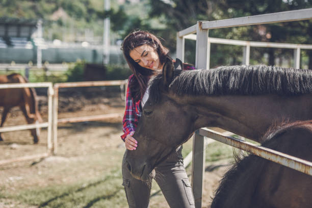 istock young woman and horse 1047643162