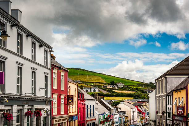 Cobh, Ireland - 15 August, 2022: town square in Cobh with colorful houses and the Lusitania Memorial statue