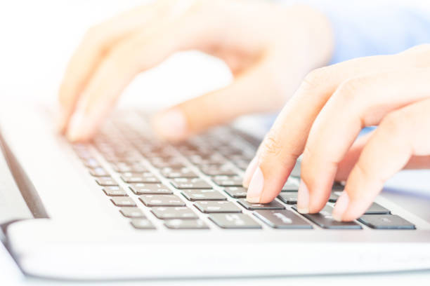 istock Man's hands holding a credit card and using laptop for online shopping. 1047643760