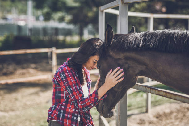 istock young woman and horse 1047643806