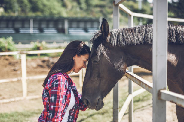 istock young woman and horse 1047644354