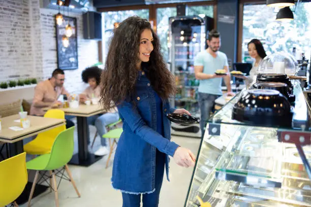 Photo of Beautiful woman standing in front of showcase