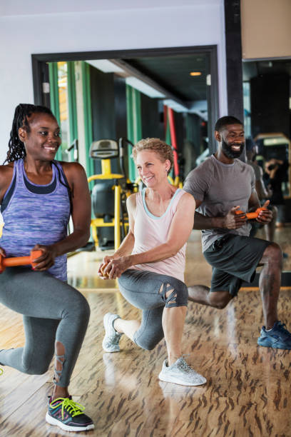 istock Group of people in gym going lunges 1047644640