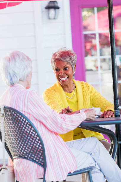 istock Two multi-ethnic senior women talking over coffee 1047645158