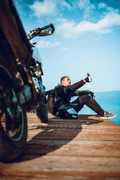 istock Motor Driver Is Making A Selfie On Wooden Deck By The Lake 1047645254