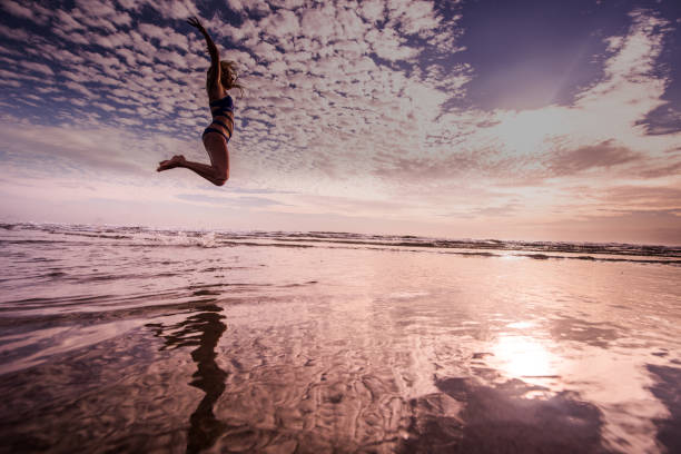 istock Happy woman jumping. 1047645494