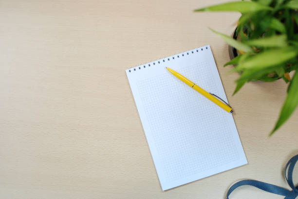 istock Notepad and pencil on wooden office desk 1047648688