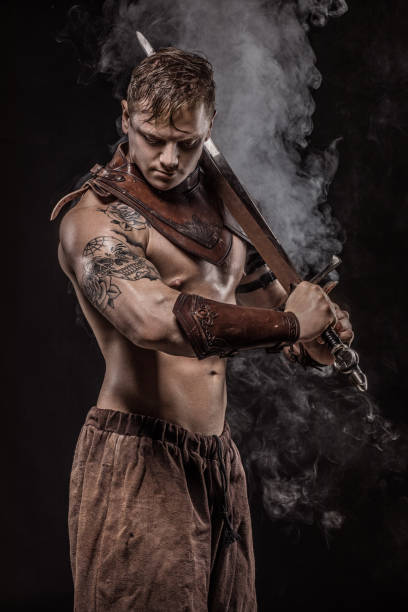 istock Sword wielding bloody viking warrior in studio shot 1047650110