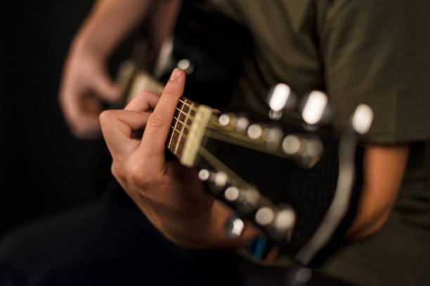 istock hands play on acoustic guitar 1047652752
