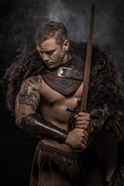 istock Sword wielding bloody viking warrior in studio shot 1047653044