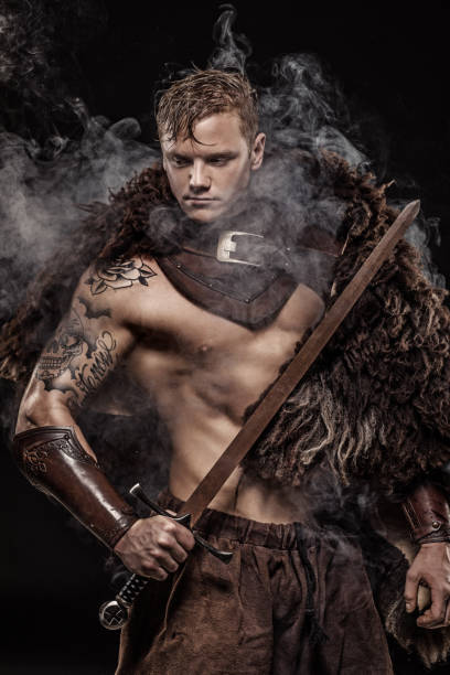 istock Sword wielding bloody viking warrior in studio shot 1047653602