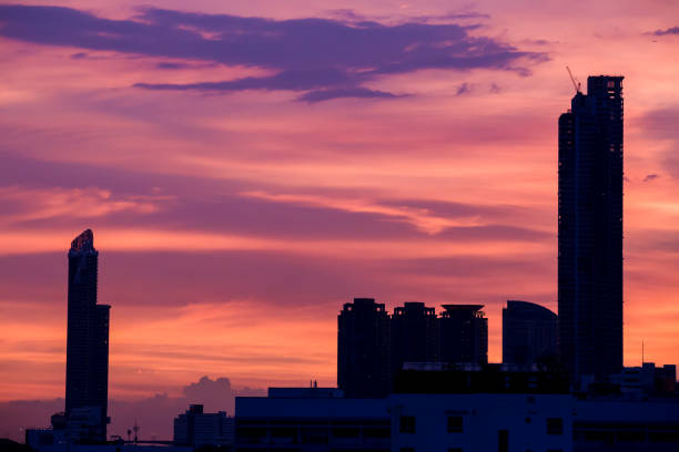 Sky with clouds over the evening city with sunset.