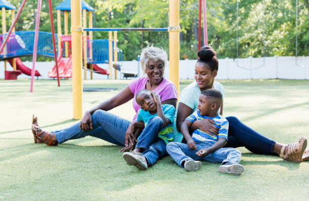 istock Multi-generation family sitting on playground 1047654022