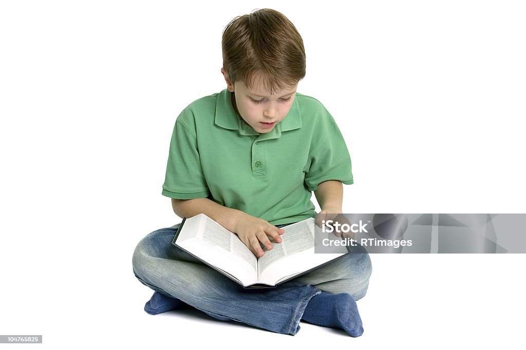 Boy reading crossed legs Boy sat crossed legs reading a book, slight shadow under his legs. Isolated on a white background. Cross-legged Stock Photo