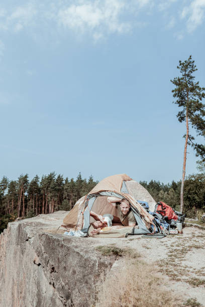 istock Couple of young and active backpackers waking up in nice tent camp 1047658752