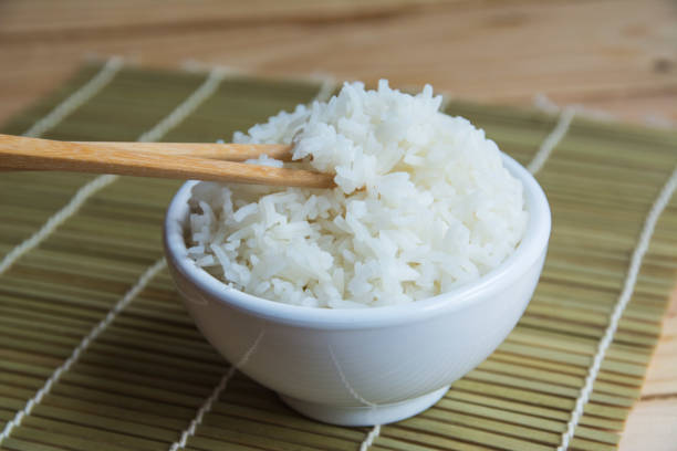 istock Jasmine rice in white cup On a bamboo mat 1047661340