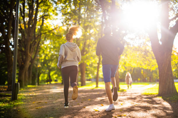 couple exercising in park. - nordic running imagens e fotografias de stock