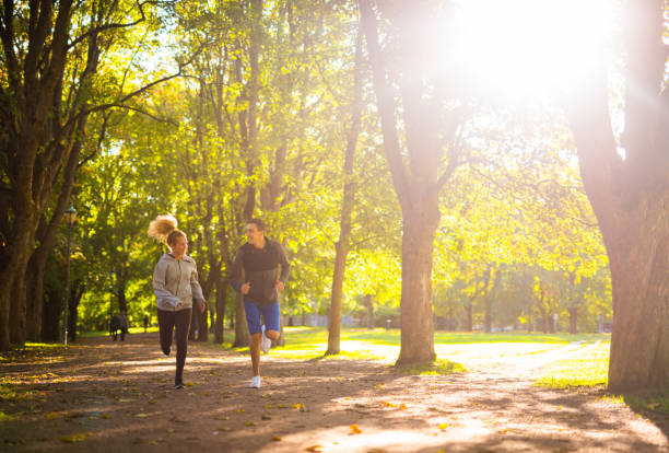 Group of friends running outdoors in the park in London. They are focused and determined.