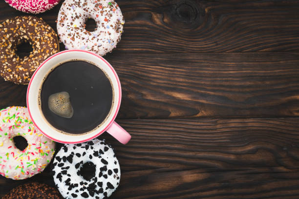 istock Coffee cup and colorful donuts 1047662342