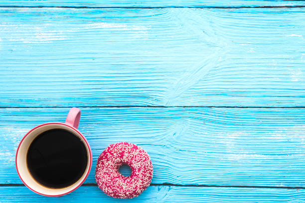 istock Coffee and chocolate donut on wooden background with space on text 1047668766