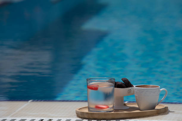 a cup of turkish coffee on the table near the pool