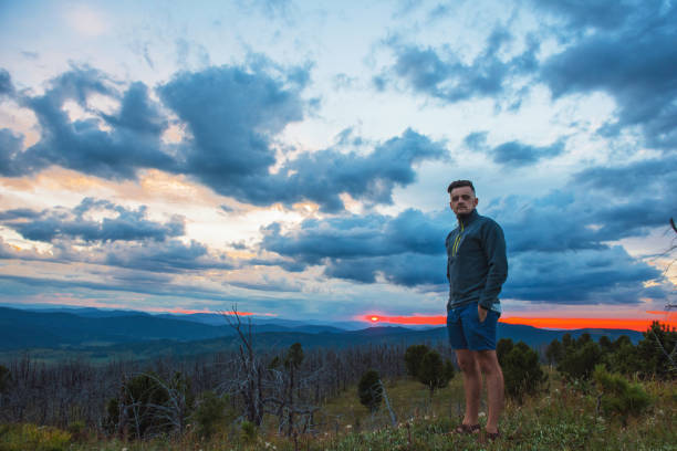 istock Man standing on top of cliff 1047677884