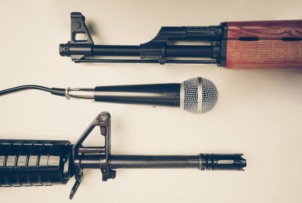 Freedom of the press Microphone vs. Rifle / Freedom of the press is at risk concept / World press freedom day concept gun laws stock pictures, royalty-free photos & images