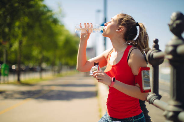 istock Young woman is drinking before exercising 1047680204
