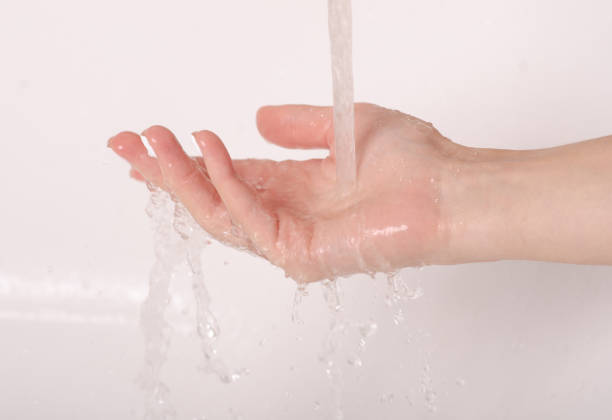 istock Soapy hands water faucet bathroom 1047680934