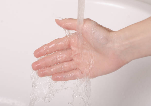 istock Soapy hands water faucet bathroom 1047680956