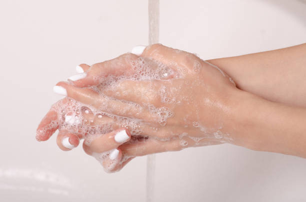 istock Soapy hands water faucet bathroom 1047681026