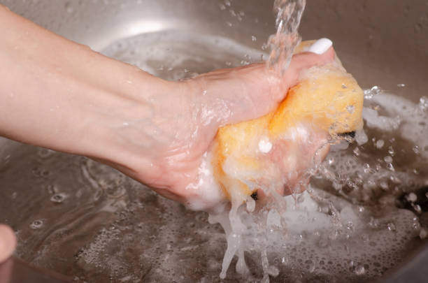 istock Sponge for washing utensils in the hands 1047683744