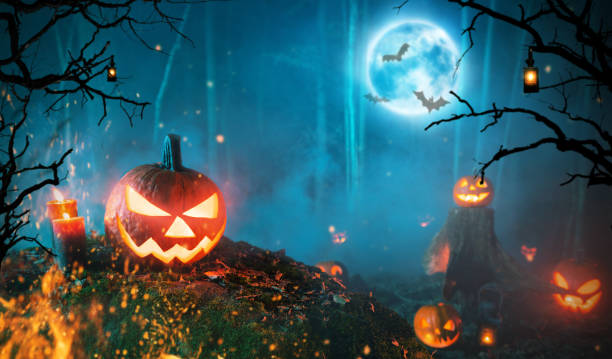 istock Spooky halloween pumpkins in dark forest 1047684264