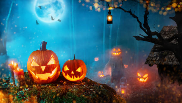 istock Spooky halloween pumpkins in dark mistery forest 1047684310