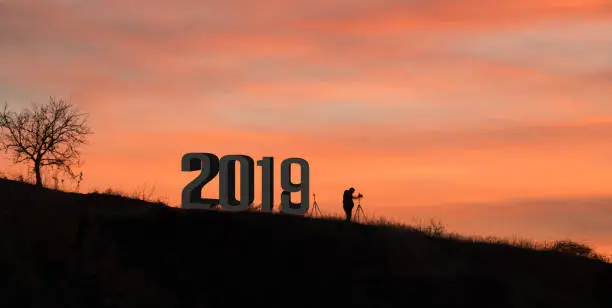 Photo of Photographer lonely tree against sunset waiting 2019