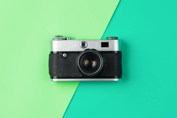 istock retro camera on color pastel background 1047684720