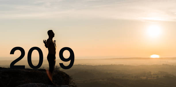 istock Man  practicing yoga during the celebration New Year 2019 1047685378