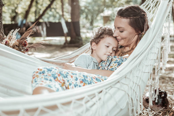 istock Pleasant young mother resting with her sun 1047690590