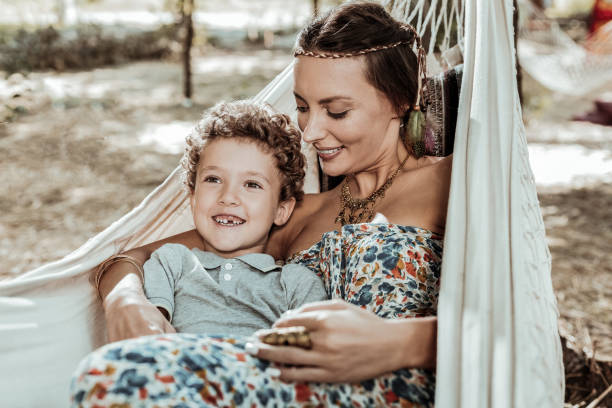 istock Nice mother and child having fun in hammock 1047690608