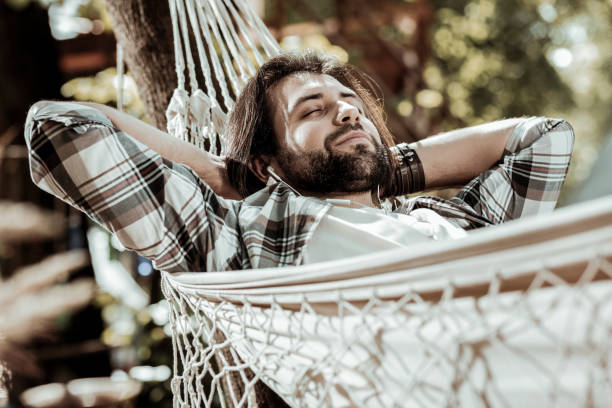 istock Relaxed bearded man chilling in the park 1047690846
