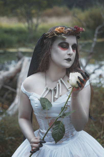 istock Creepy dead bride with rose. Halloween scene 1047693158
