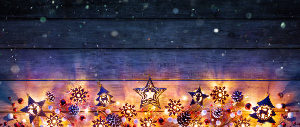 istock Christmas Lights And Decoration On Rustic Wooden Plank 1047693592