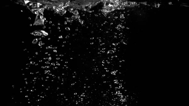 istock Water bubbles floating on black background which represent refreshing of refreshment from soda or carbonated drink 1047693620