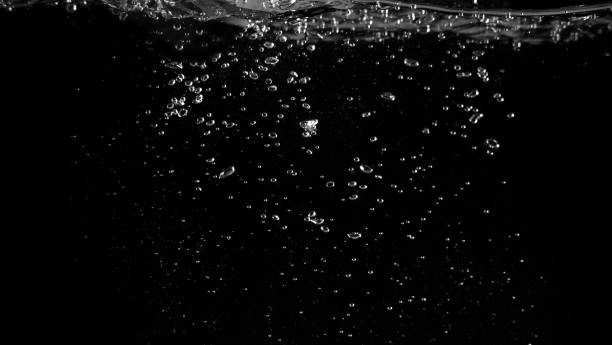 istock Water bubbles floating on black background which represent refreshing of refreshment from soda or carbonated drink 1047693624