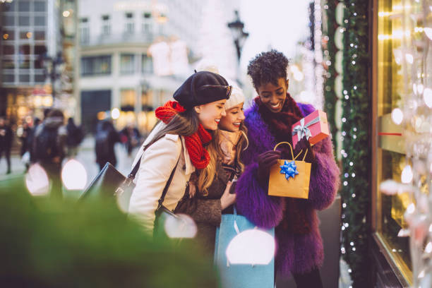 Friends are buying Christmas presents Friends are buying Christmas presents window shopping stock pictures, royalty-free photos & images